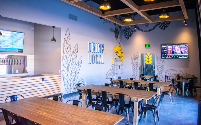 4 By 4 Brewing Company Seating Area with Multiple Wall Murals