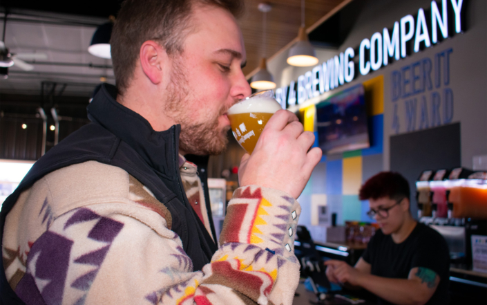 Man at 4 By 4 Brewing Company Drinking Beer