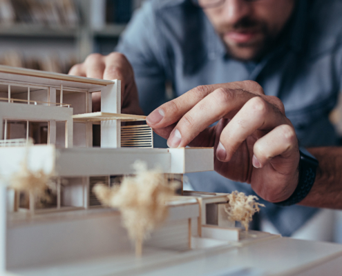 Architect Building a model of home with wood