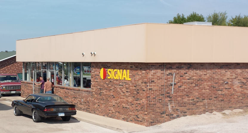 Exterior view of and old SIGNAL convenience store building