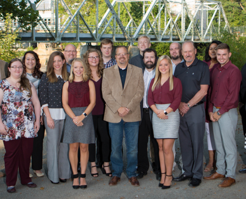 Torgerson Design Partners employees in business casual attire in front of bridge