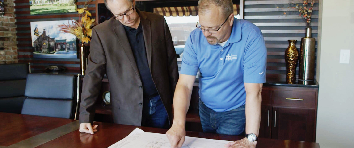 Torgerson Design Partners Employees Looking Through Blueprints