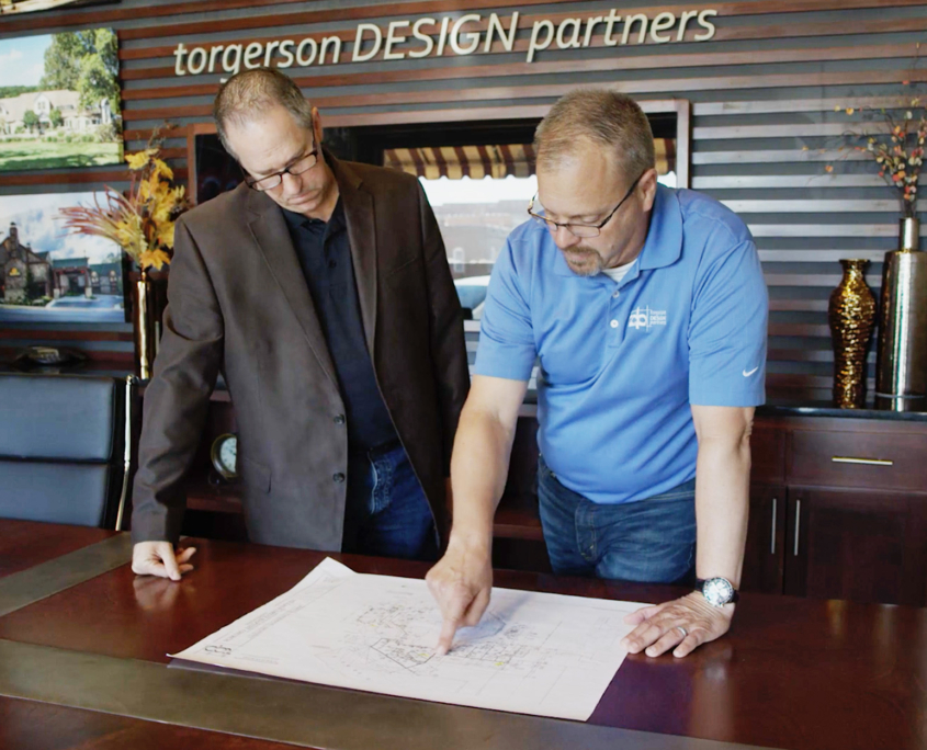 Torgerson Design Partners Employees Looking Through Blueprints