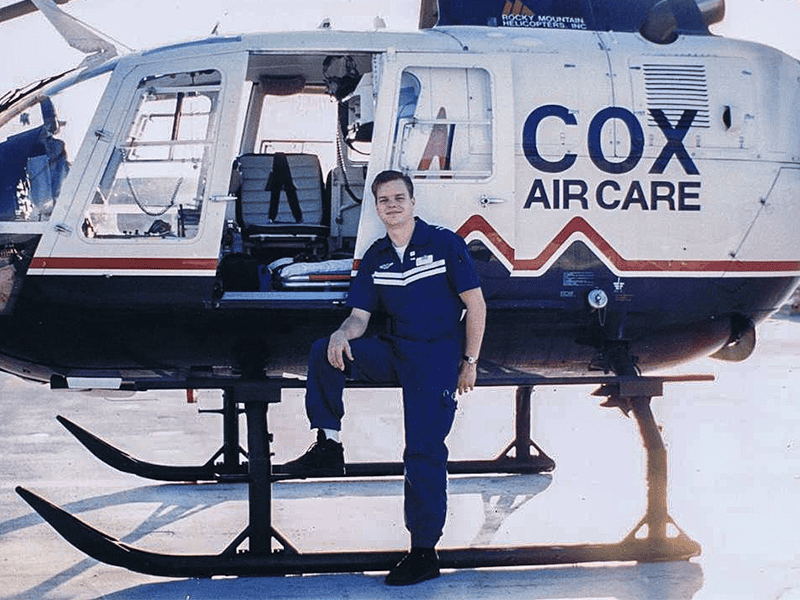 John Torgeron in front of a Cox Aircare helicopter