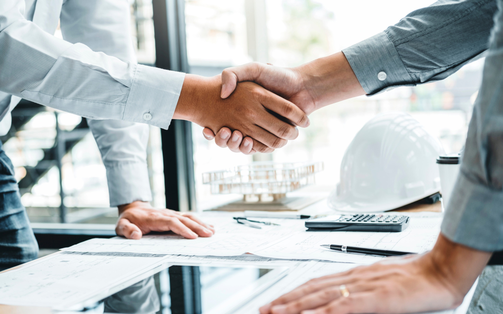 Engineer handshake meeting for architectural project and working with partner engineering on workplace