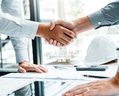Engineer handshake meeting for architectural project and working with partner engineering on workplace