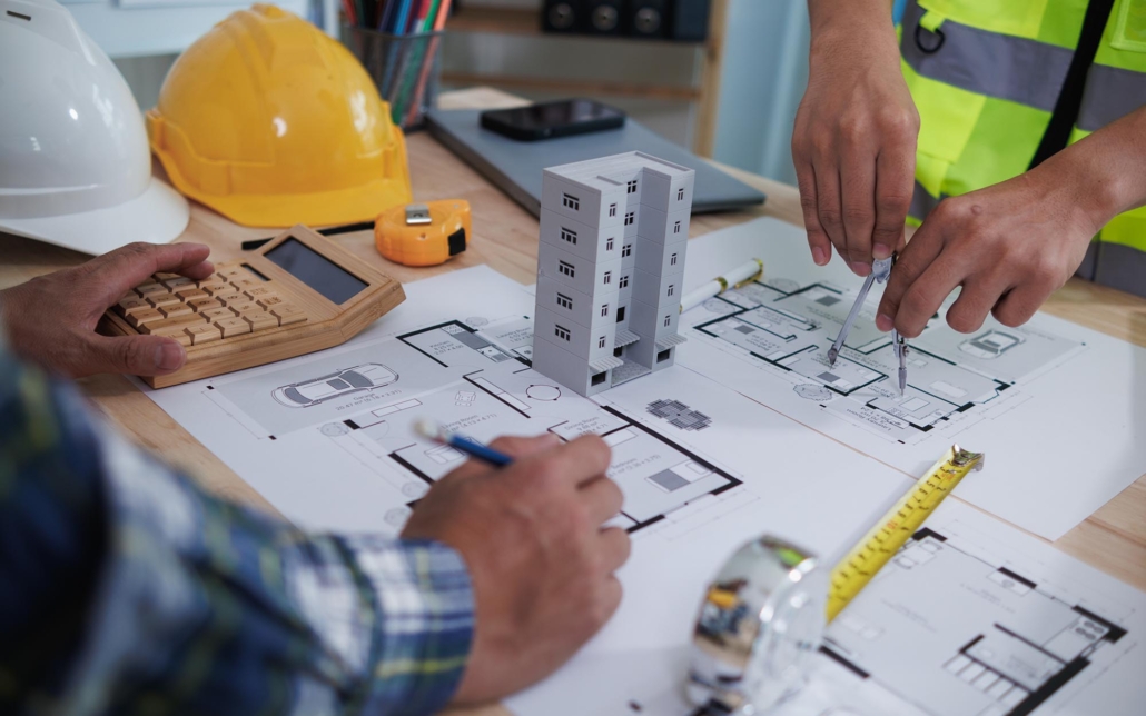 Team of construction workers planning blueprints for commercial building