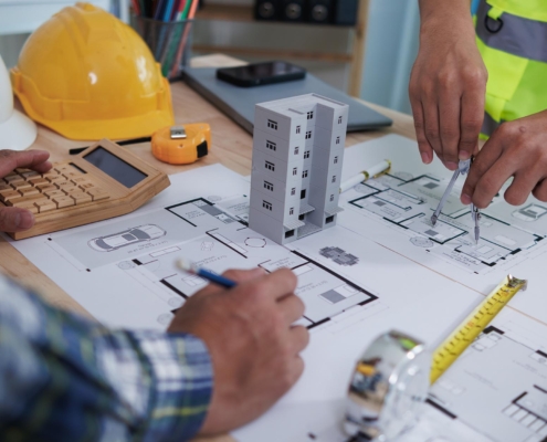Team of construction workers planning blueprints for commercial building